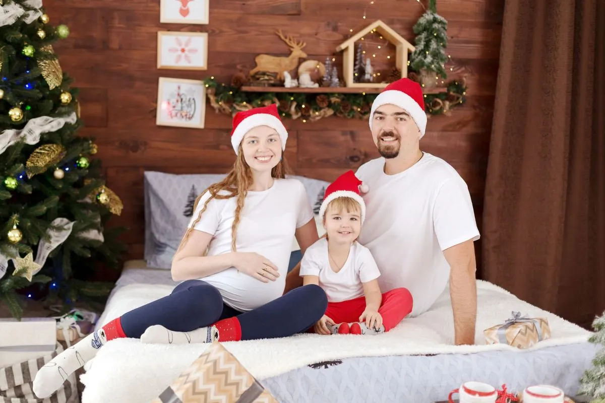 Family of three in Christmas decorations
