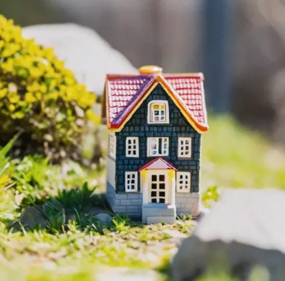 an image of a miniature house placed outside